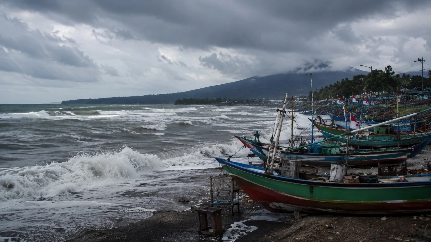 Gelombang tingi menghantam pesisir pantai, perahu nelayan